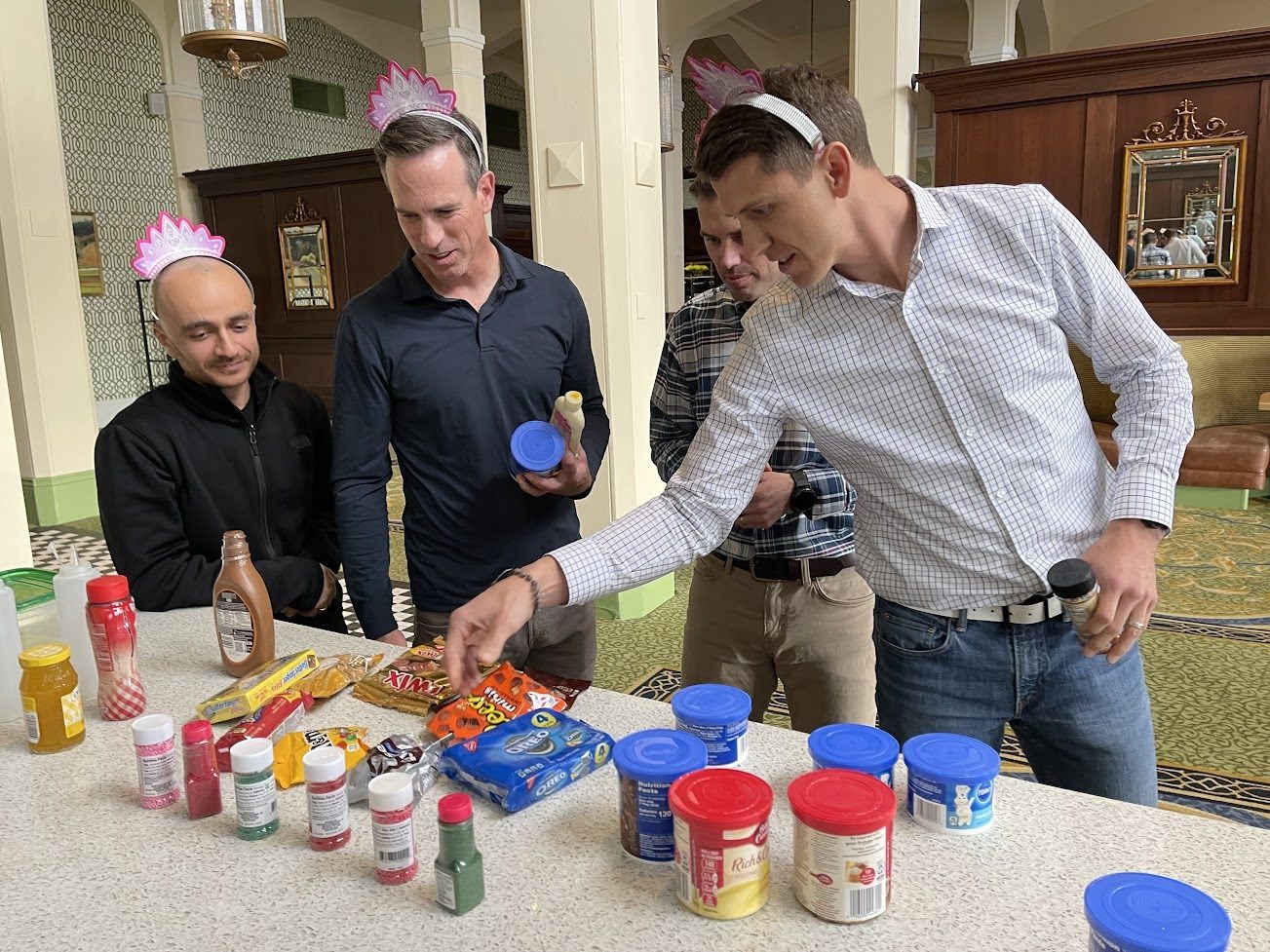 Teammates working together on a table of desserts